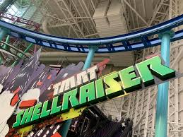 The green and black TMNT Shellraiser roller coaster sign inside Nickelodeon Universe at American Dream mall in New Jersey